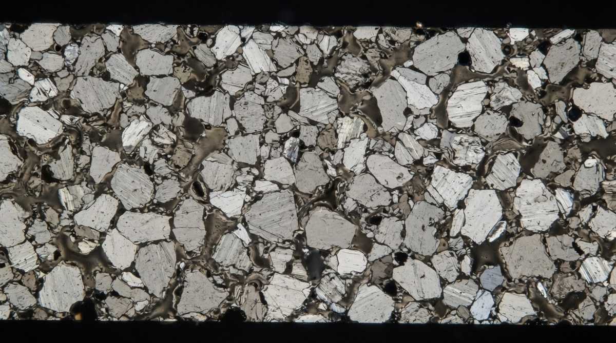 Microscope cross-section of 96% alumina showing grain structure and glassy sintering-aid phase