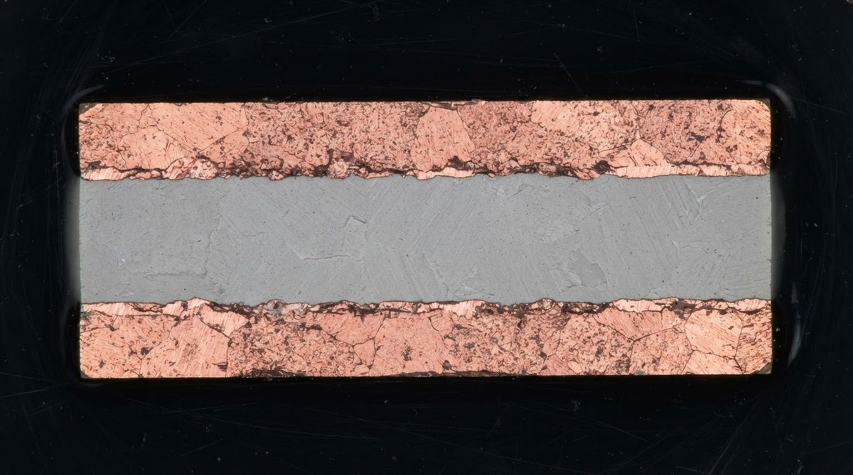 Cross-section of a DBC copper-AlN-copper stack under a microscope