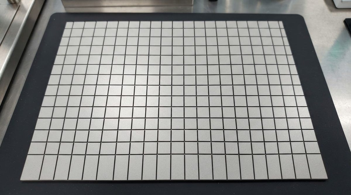 Laser-scribed AlN ceramic panel prepared for snap singulation