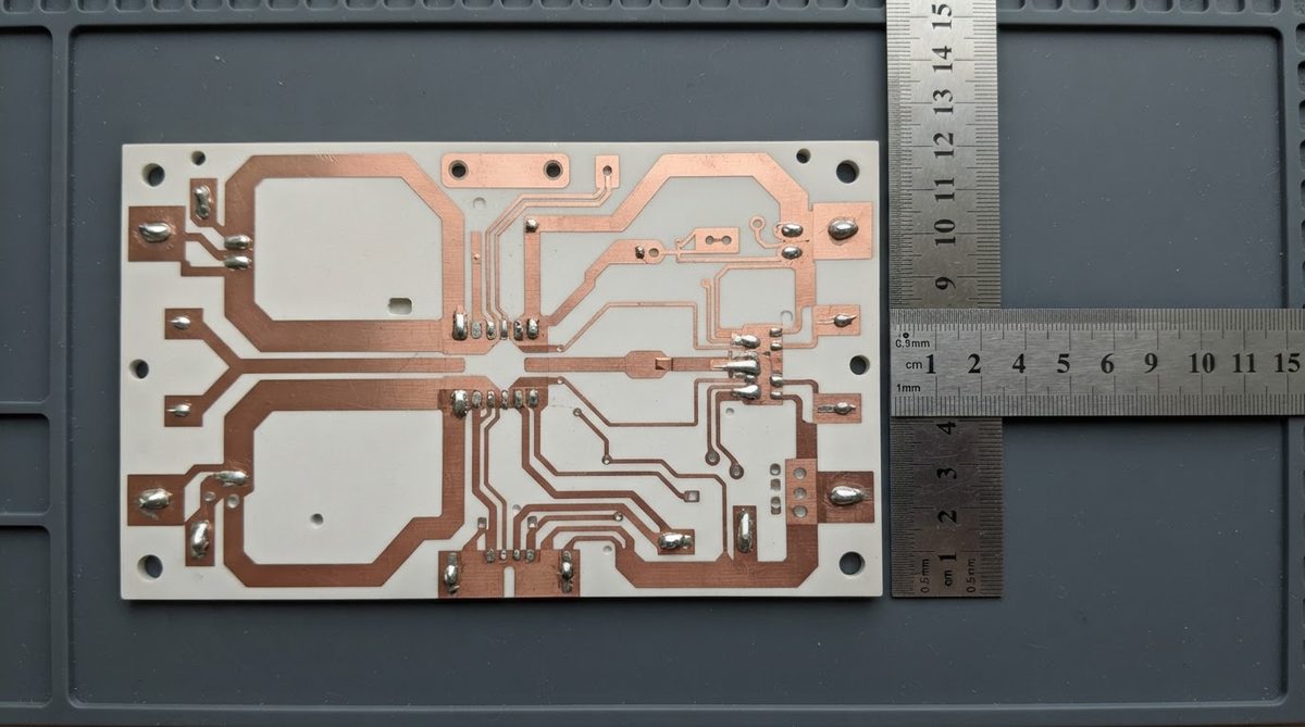 Metallized AlN substrate with copper traces next to a ruler for scale