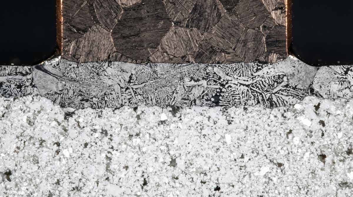 Cross-section of a brazed copper-to-ceramic joint under microscope