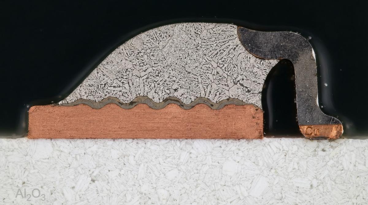 Cross-section of a solder joint on a ceramic PCB showing copper pad and component lead