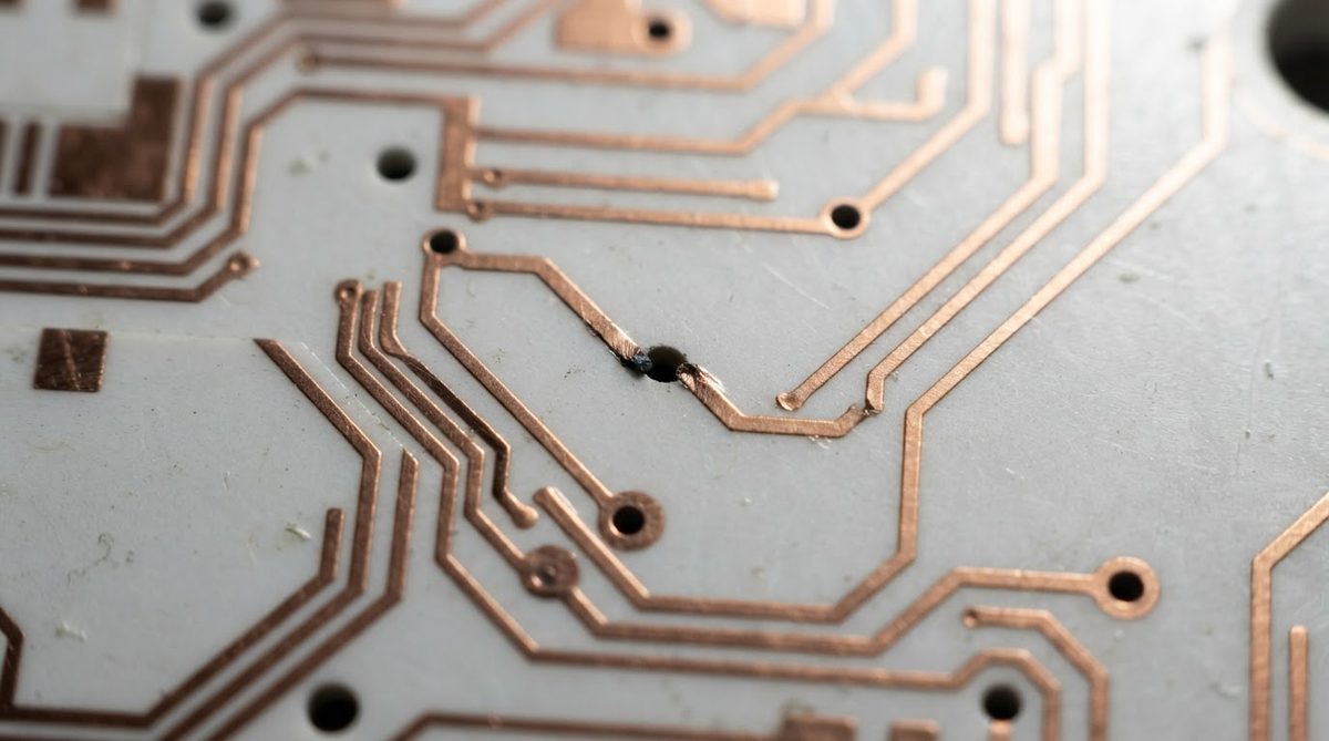 Fine copper traces on a ceramic substrate with a visible nick defect