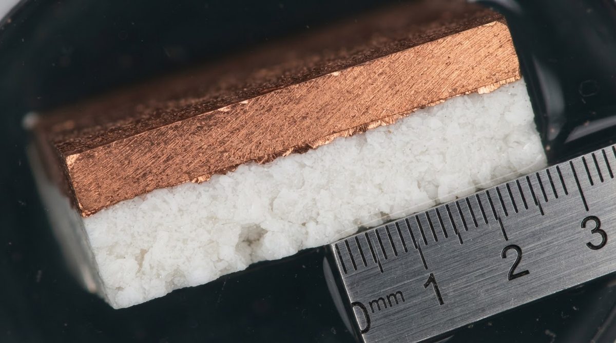 Cross-section of a copper-metallized alumina ceramic substrate under magnification