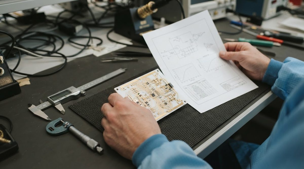 Engineer comparing a ceramic substrate datasheet against a physical sample