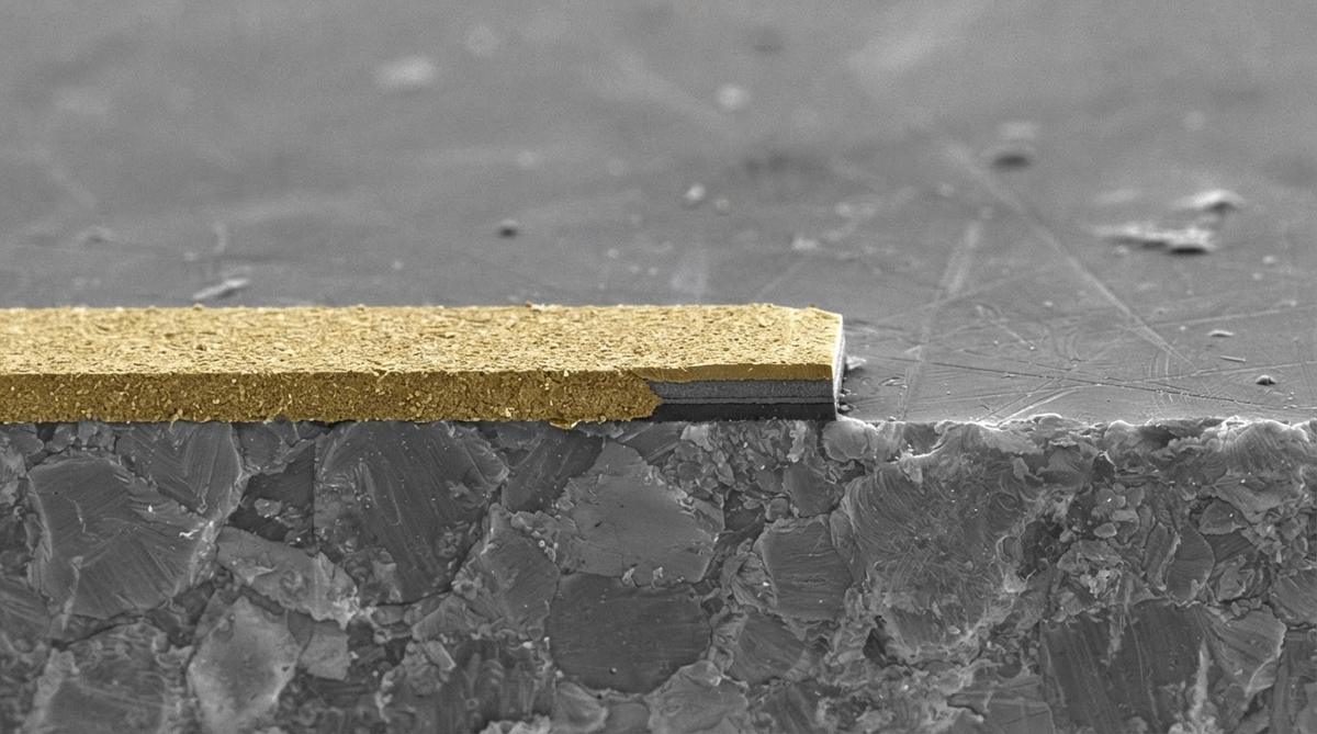 Microscope view of thin-film gold traces on polished ceramic