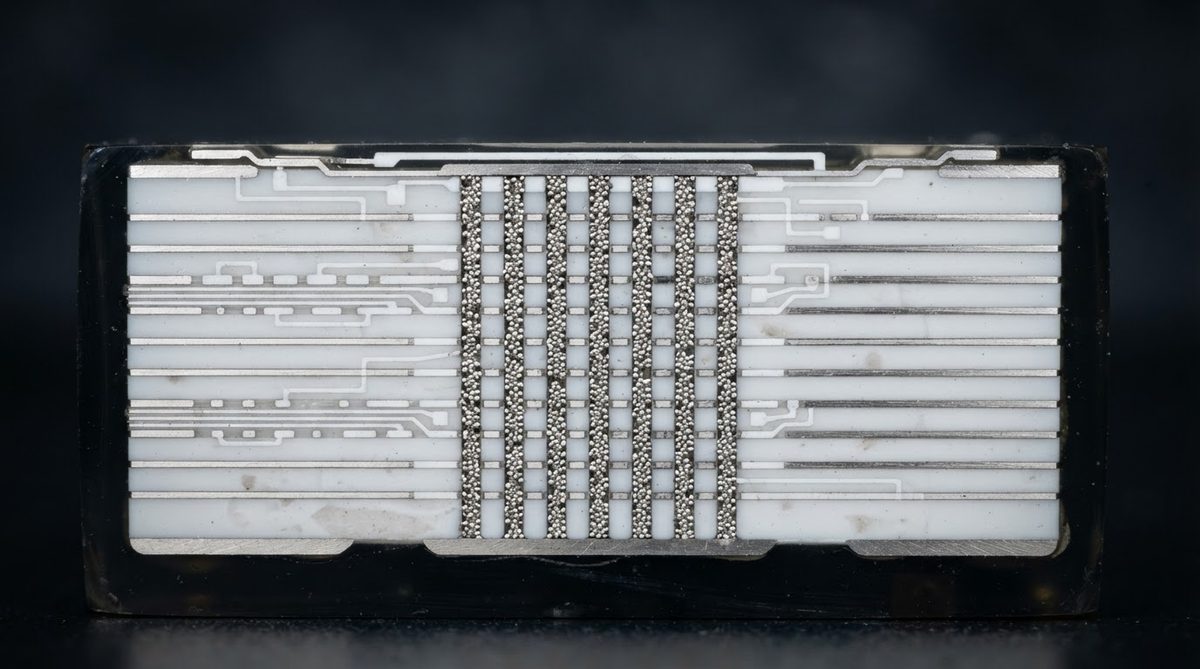 Cross-section of an LTCC substrate revealing internal silver conductor layers and thermal vias