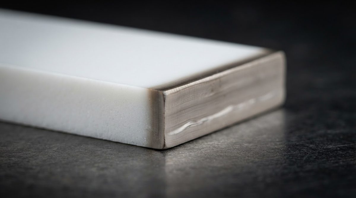 Close-up of a laser-cut alumina edge showing the recast layer