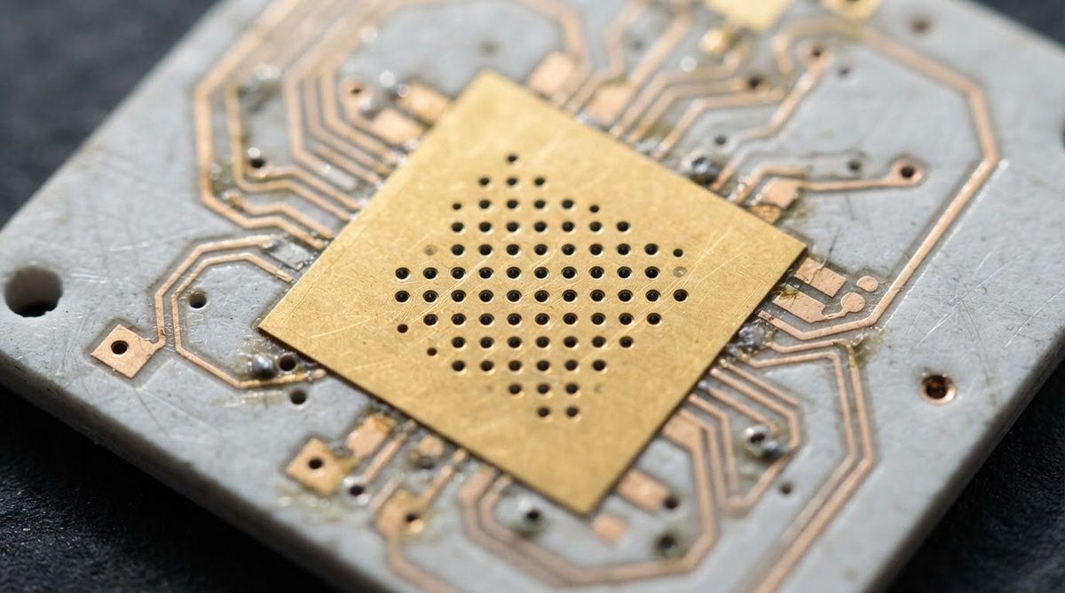 Thermal via array on a ceramic PCB beneath a copper heat-spreading pad